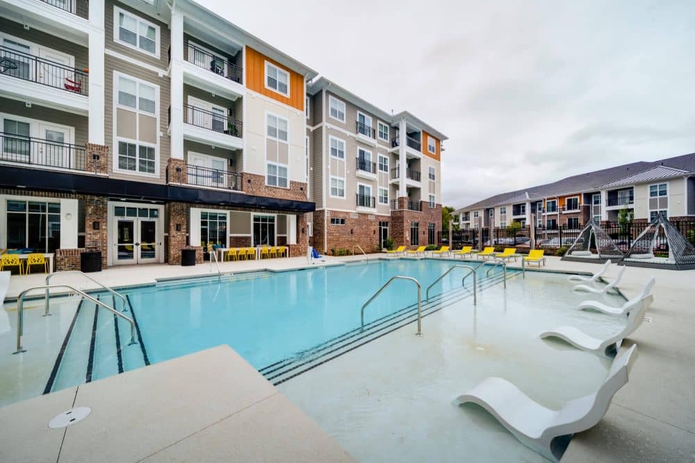 the eastern on 10th off campus apartments near east carolina university ecu resort style pool with sundeck and lounge seating